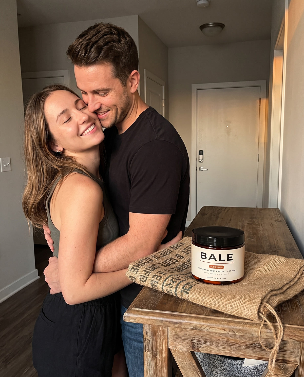 She leans in close to him, the Bleu Hour jar on the console table
