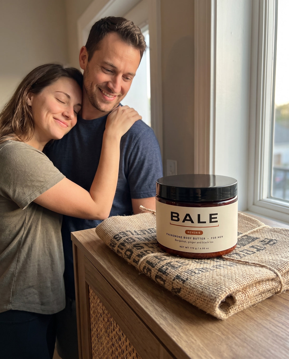 She leans in close to him, the Reverie jar on the console table