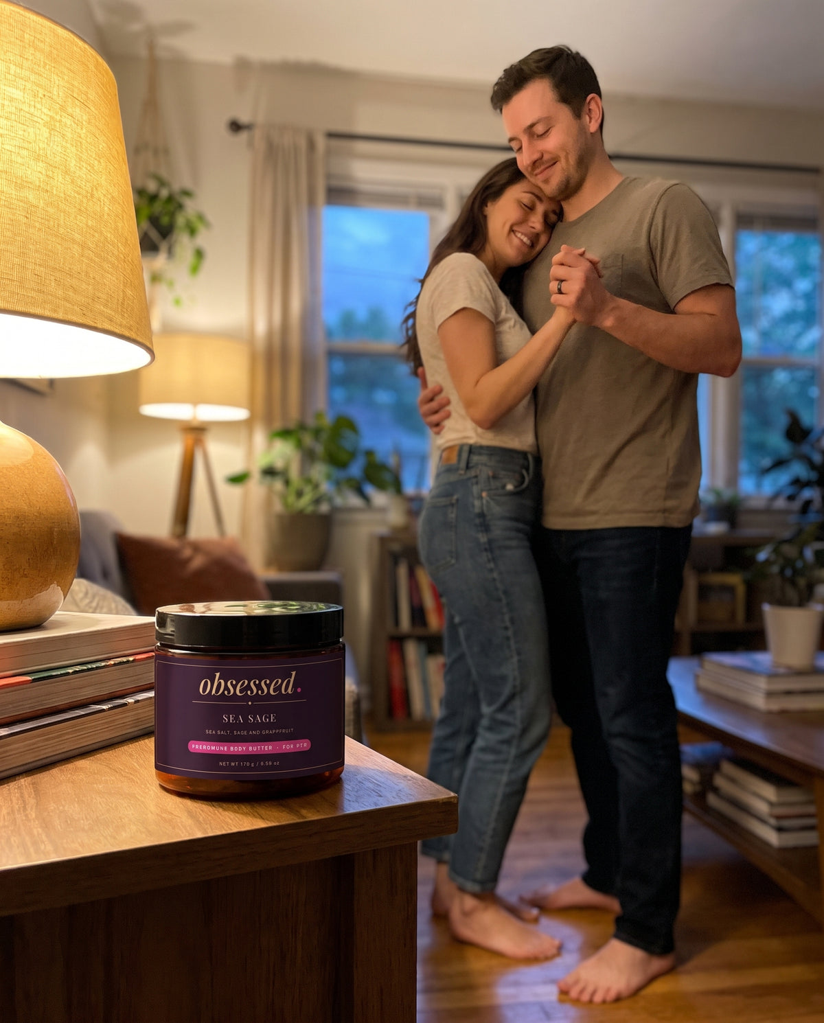A couple slow dance at dusk, the Sea Sage jar on the side table