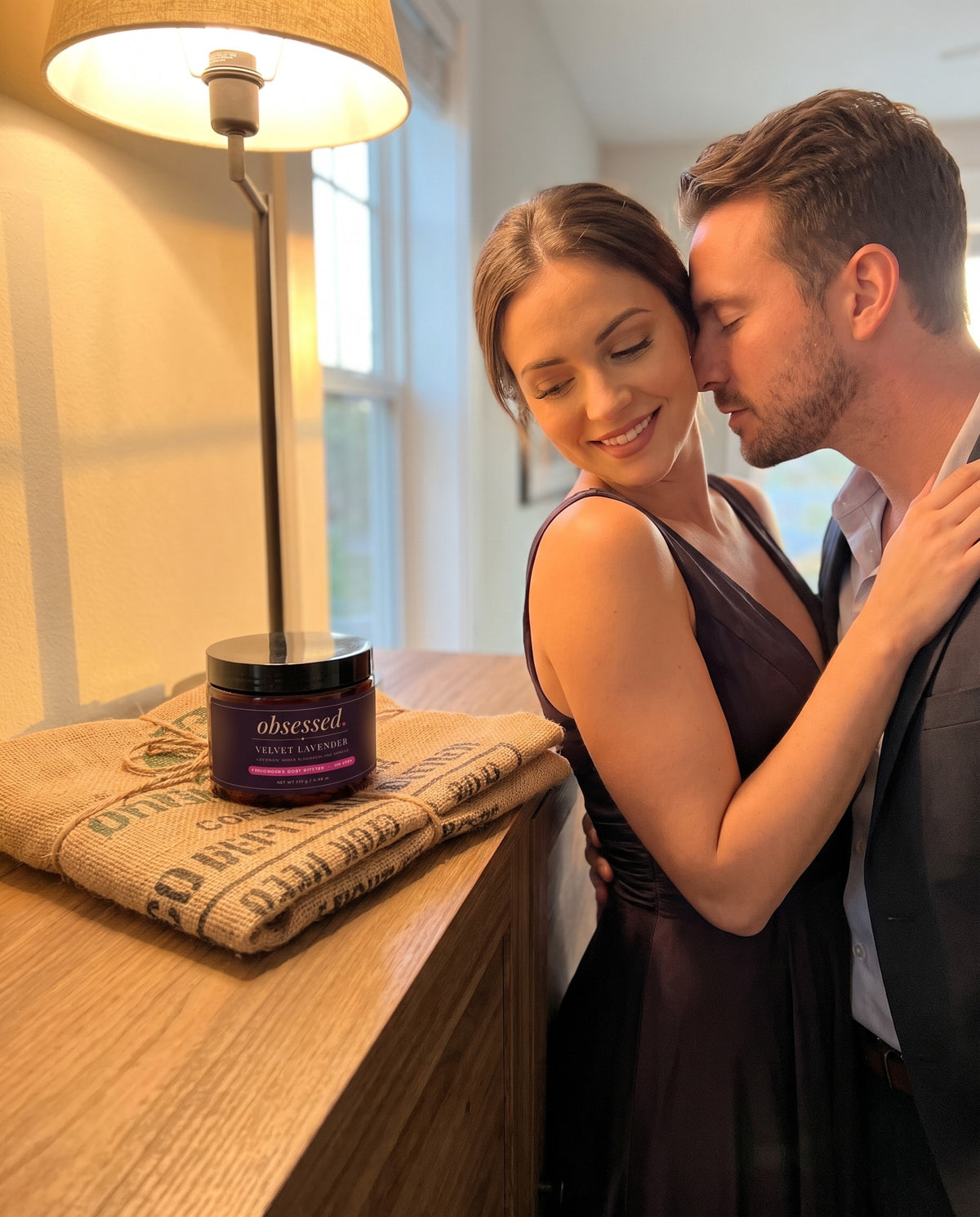 Her partner leans in close, the Velvet Lavender jar on the console table beside them